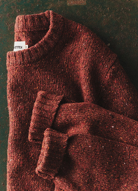editorial flatlay of The Seafarer Sweater in Ember Donegal, by Taylor Stitch