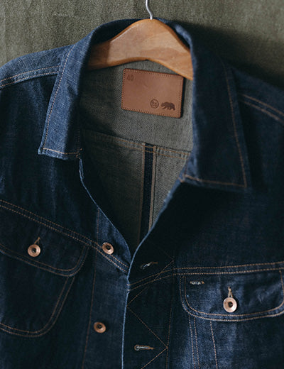 editorial image of The Long Haul Jacket in Rinsed Indigo Selvedge hanging, by Taylor Stitch